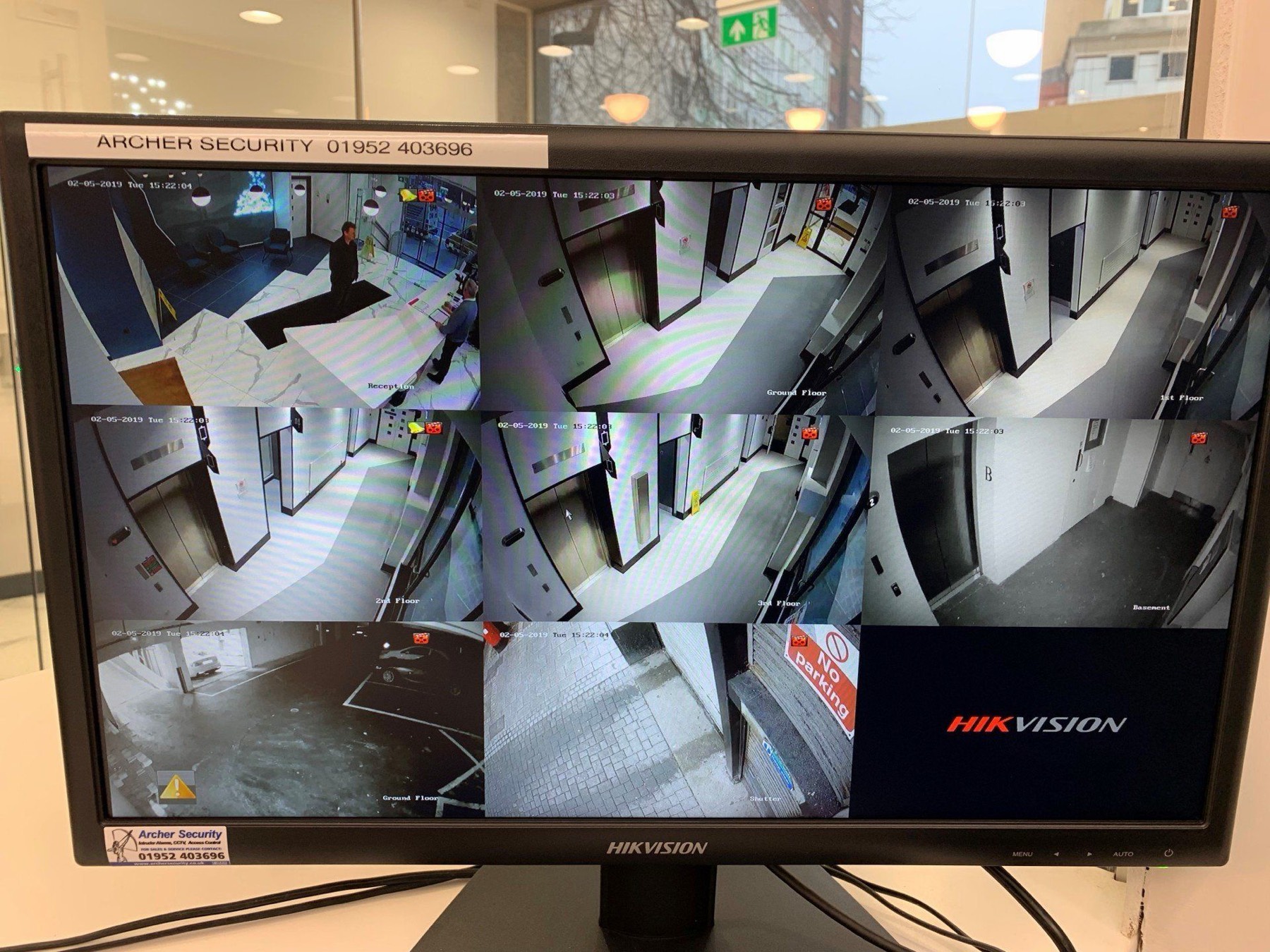 CCTV monitor displaying nine camera views of a building