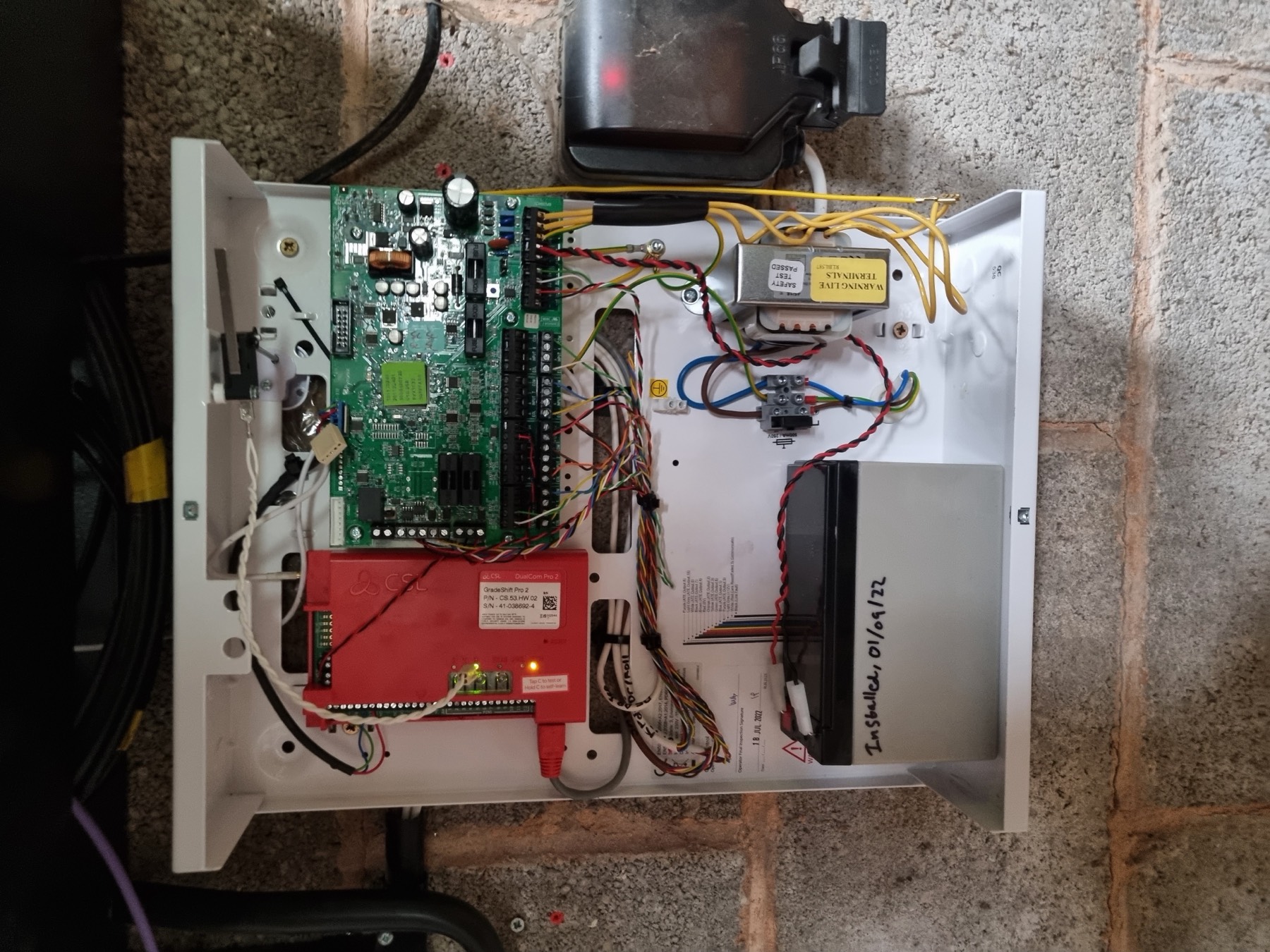 The internals of an alarm panel wired by Archer Security.